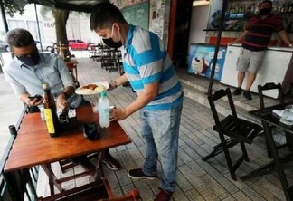 Em vários lugares, bares e restaurantes têm regras de distanciamento de mesas e número de clientes (Foto: Reuters)