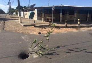 Para evitar acidentes, um galho de árvore foi colocado para sinalizar o local onde o buraco se formou (Foto:Paola Carvalho/FolhaBV)